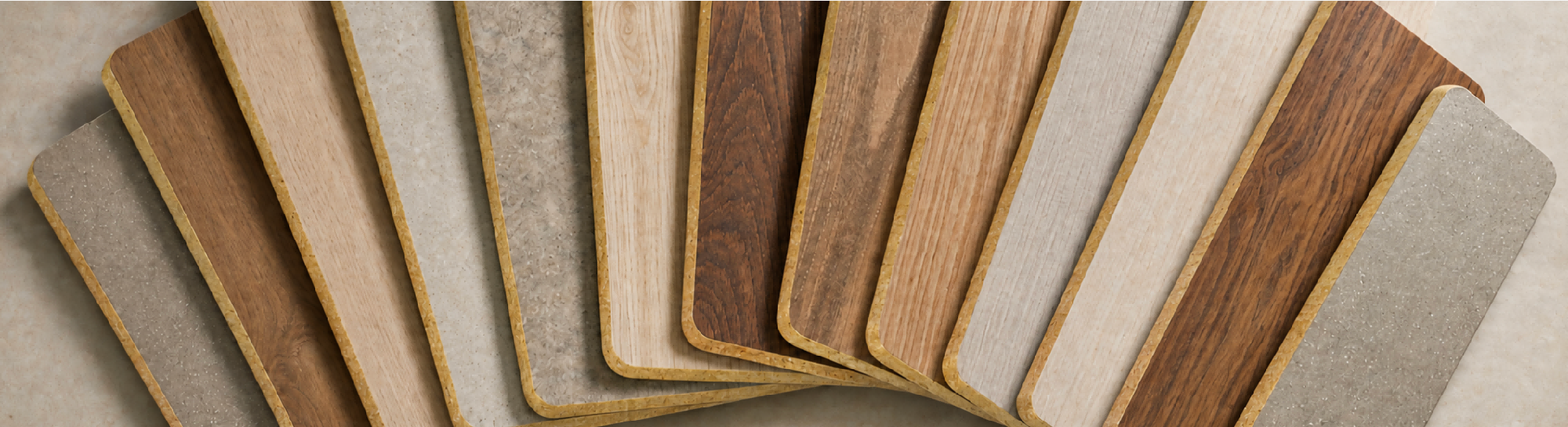A fan of finished mineral panels in woodgrain and stone surfaces